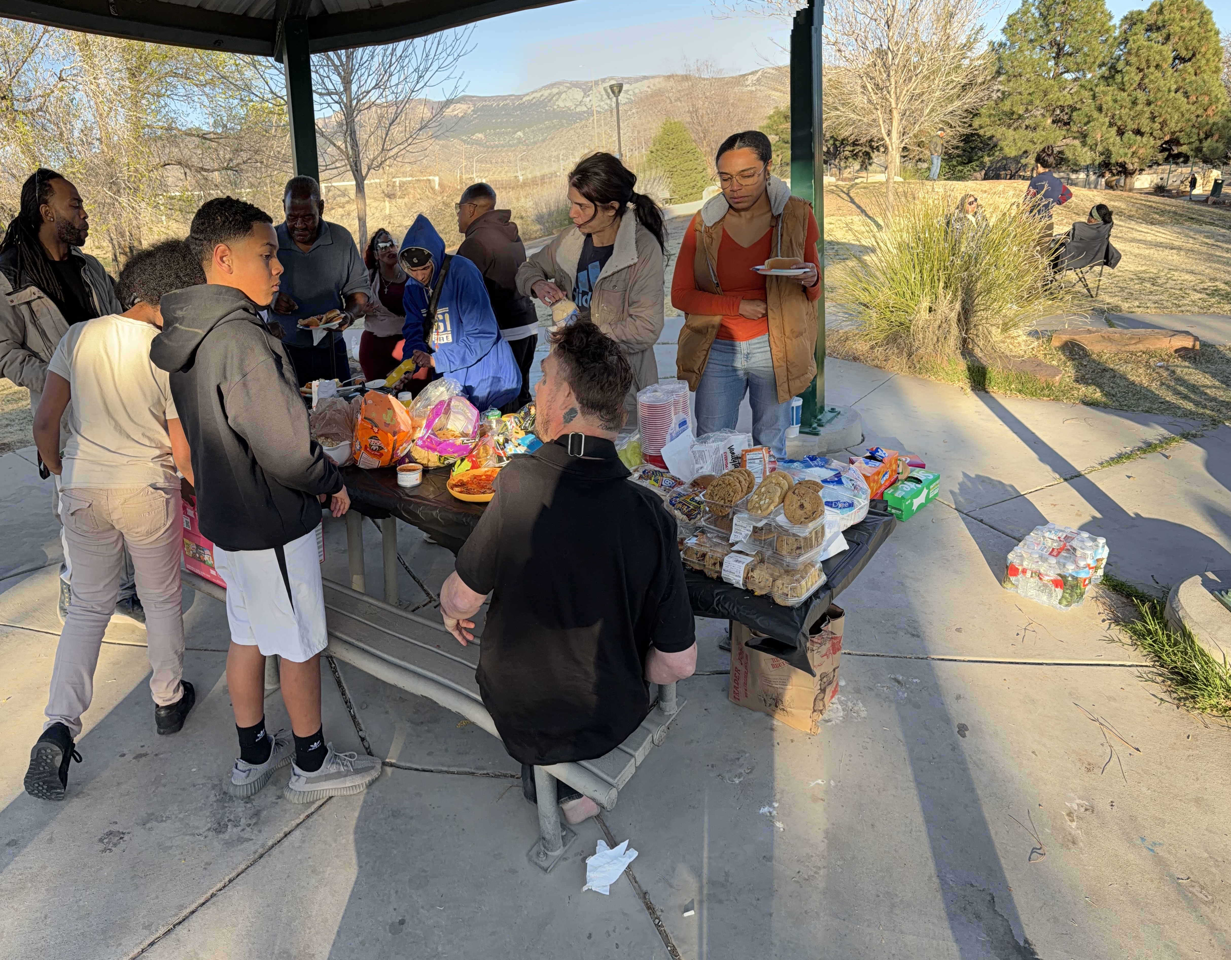 Serving food at a community cookout under the pavilion