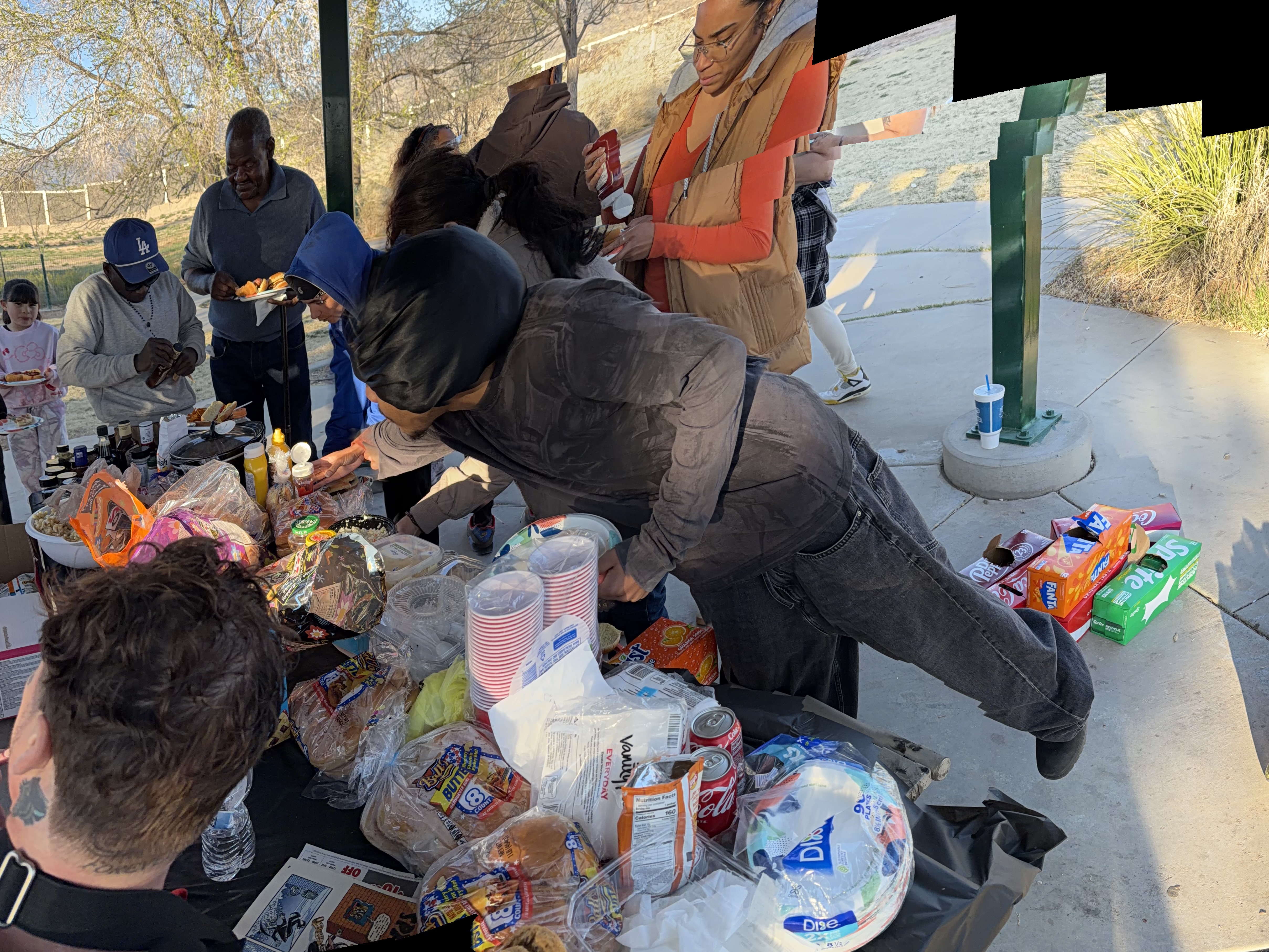 Community members sharing a meal at a park picnic